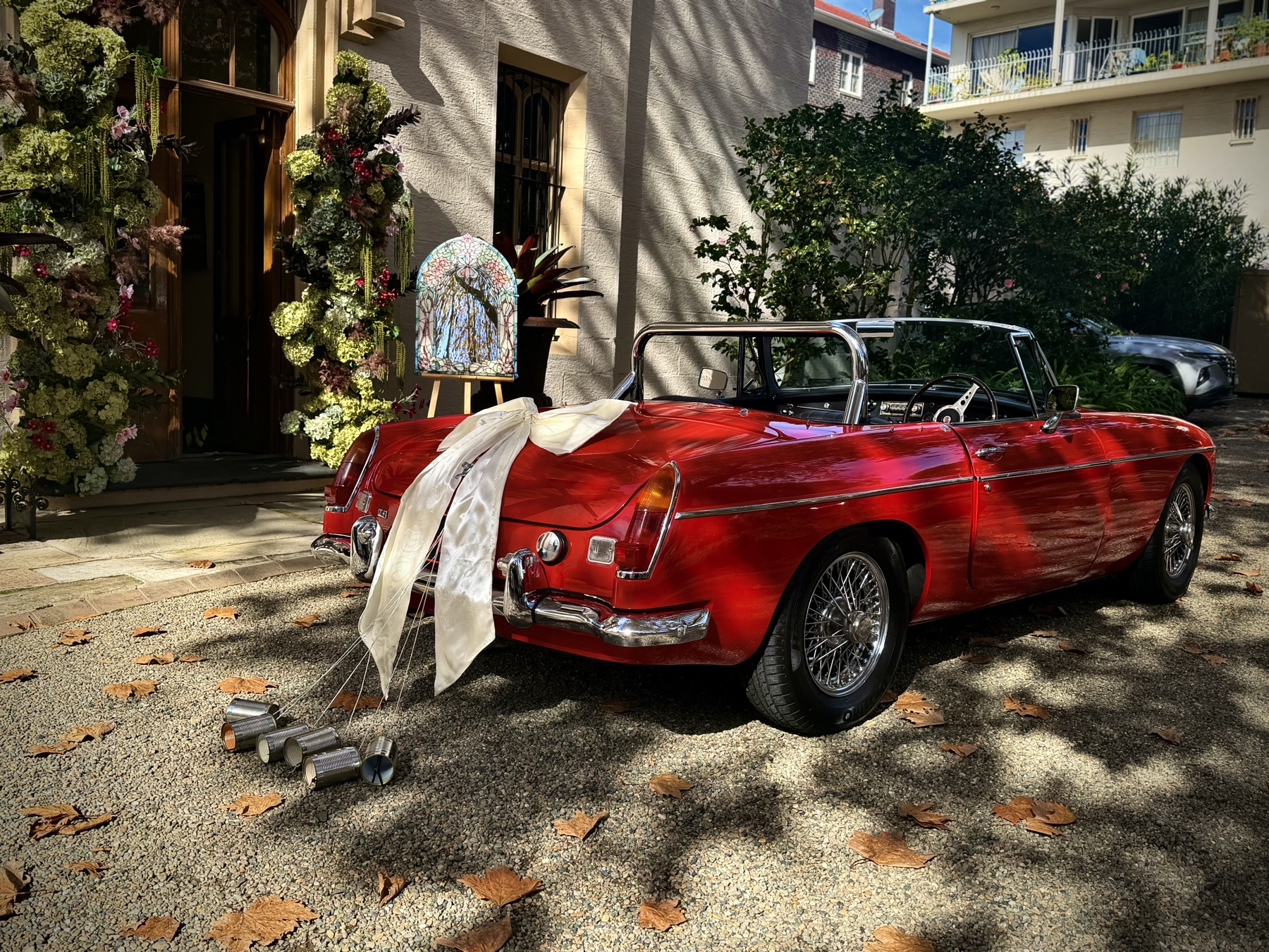 1971 MG B MK II wedding car dressed with ribbons at Sydney venue