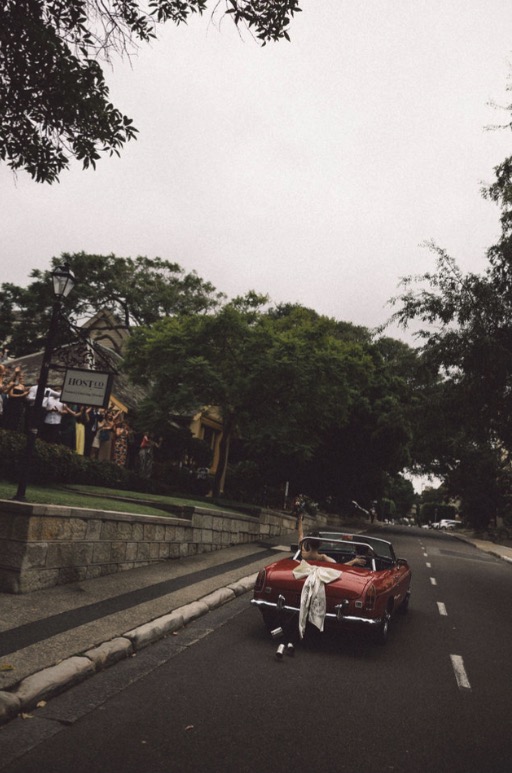 Couple with 1971 MG B vintage wedding car on Sydney street